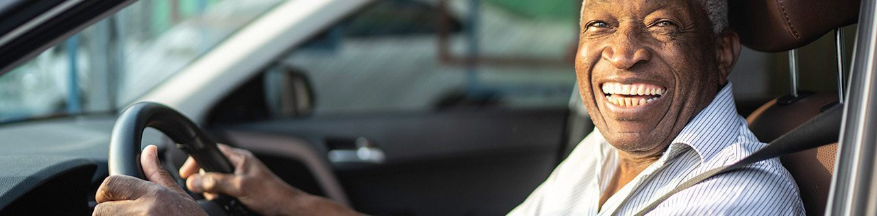 Man happily behind wheel of car