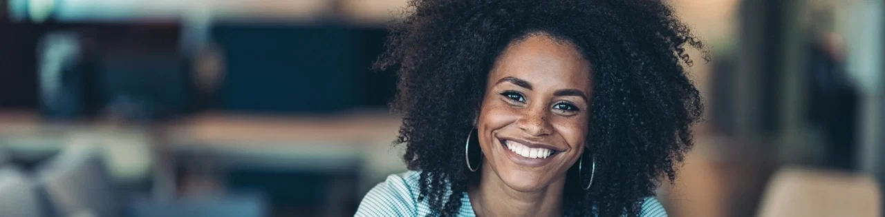 Young lady with laptop and smiling