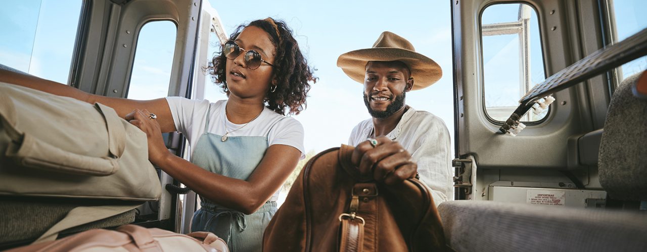Couple putting luggage in their vehicle