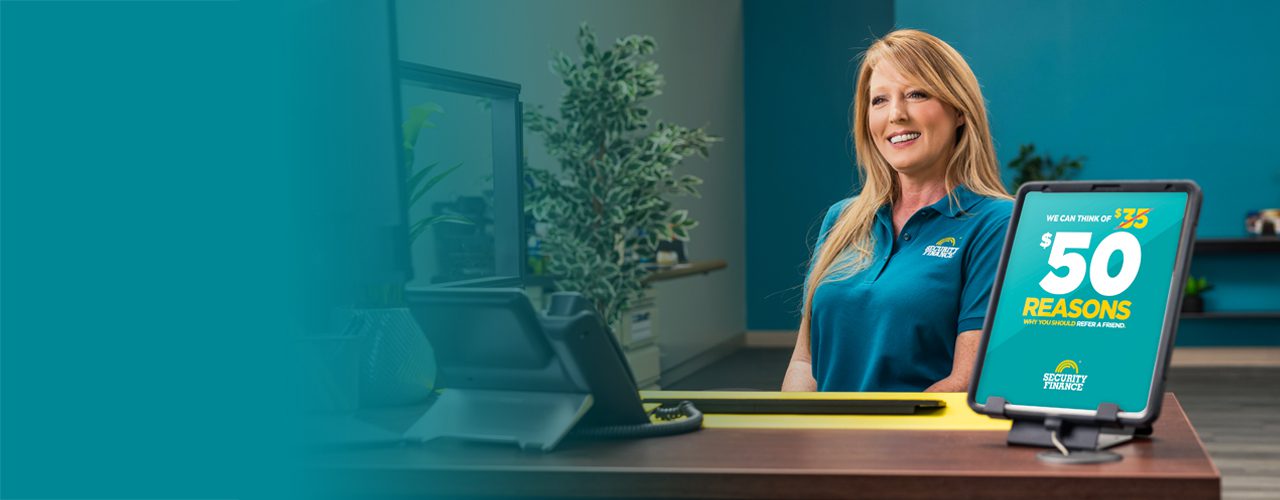 Friendly Security Finance employee smiling at her desk