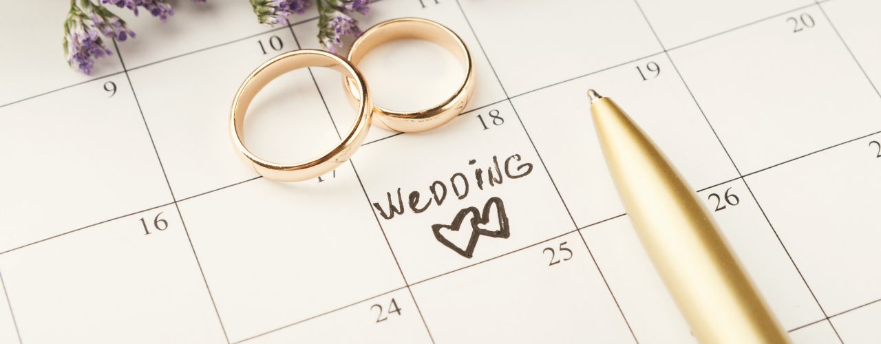 Word wedding on calendar with sweet flowers
